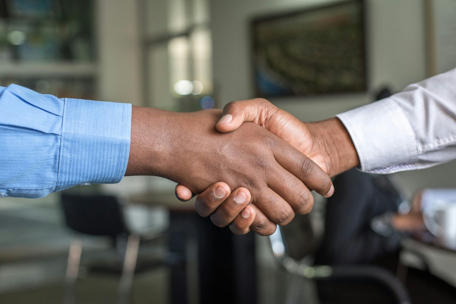 Handshake symbolizing agreement to terms and conditions on BrainFuel wellness website